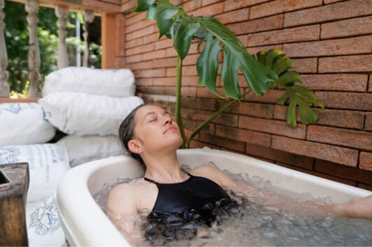 Woman relaxing in an ice bath outdoors.